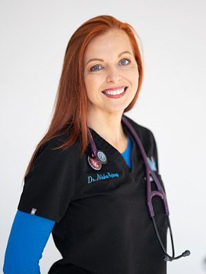 Dr. Alisha Spivey - female veterinarian with long red hair