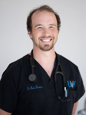 Dr. Kohl Brandon - Male veterinarian wearing a black v-neck tshirt