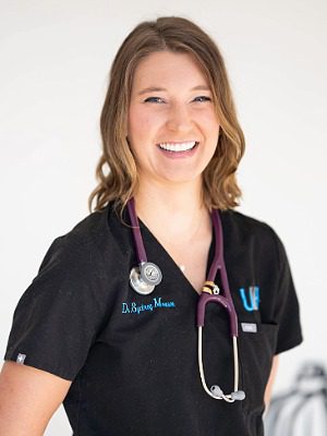 Dr. Sydney Mouser - female veterinarian with shoulder length medium brown hair