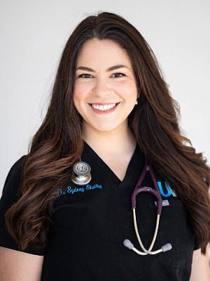 Dr. Sydney Shelby - female veterinarian with long brown hair